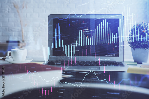 Financial chart drawing and table with computer on background. Multi exposure. Concept of international markets.