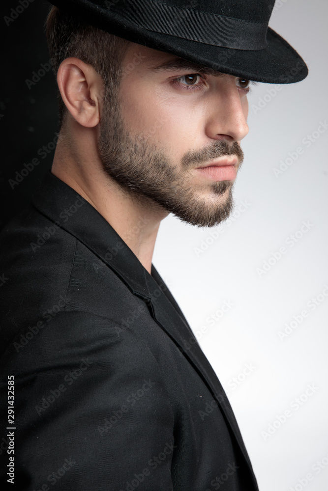 close up of seductive young man wearing black hat