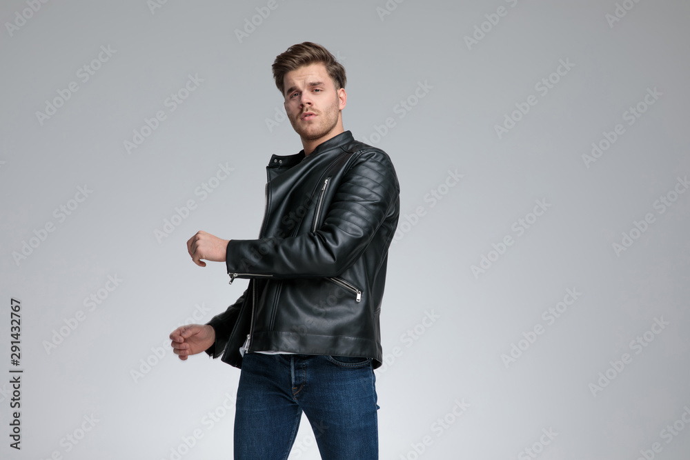 casual man standing twisted with one hand over body seductive casual man standing twisted with one hand over body seductive