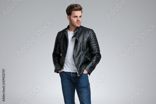 casual man standing with hands in pockets and looking away