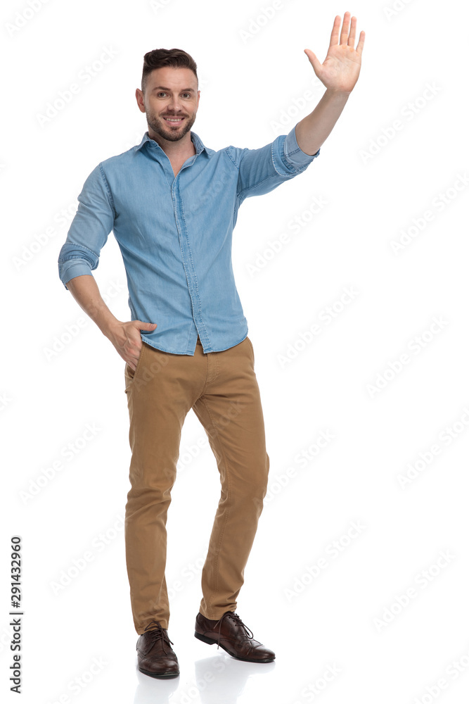 casual man standing with one hand in pocket and saluting casual man standing with one hand in pocket and saluting