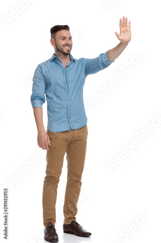 casual man standing and waving his hand happy © Viorel Sima