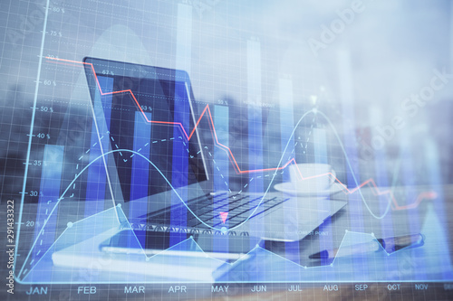 Stock market chart hologram drawn on personal computer background. Double exposure. Concept of investment. © peshkova