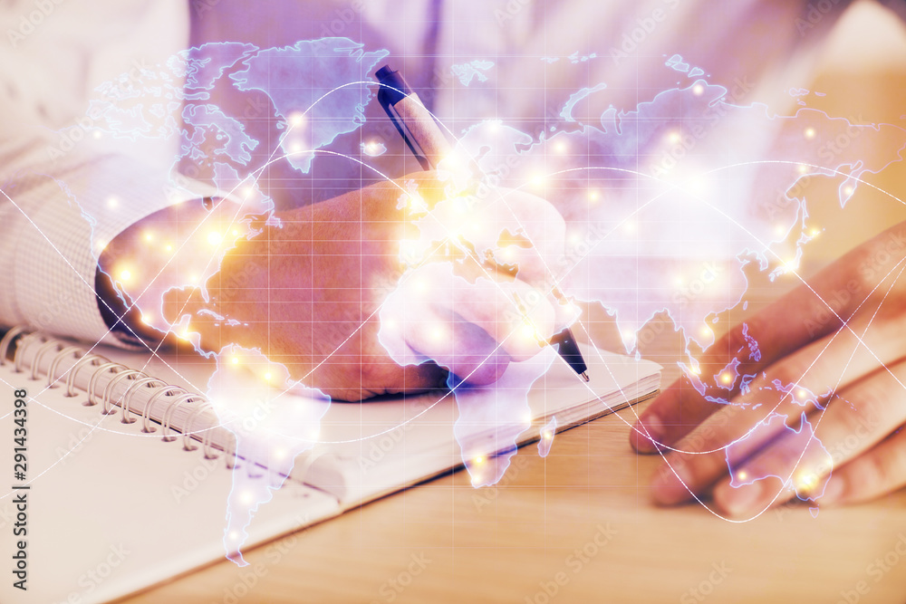 Double exposure of Man writing in notepad with business icons on background. Double exposure of Man writing in notepad with business icons on background.