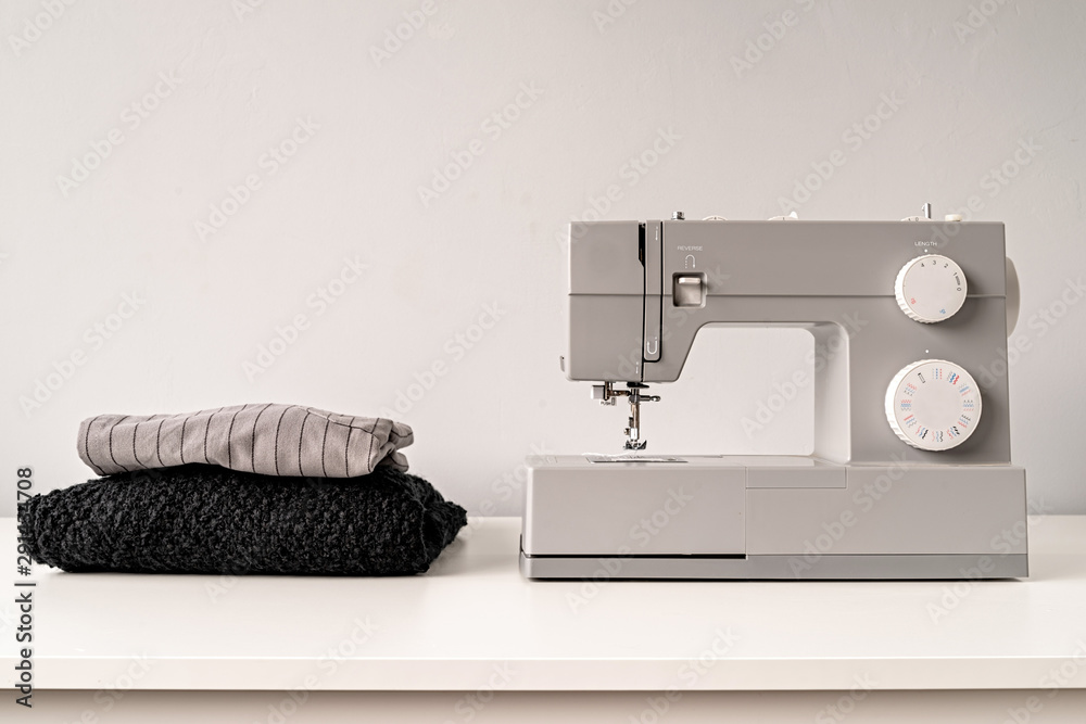 sewing machine on tailor table with fabric with copy space