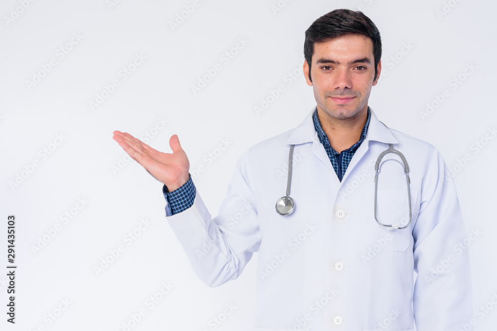 Portrait of young Persian man doctor showing something Portrait of young Persian man doctor showing something