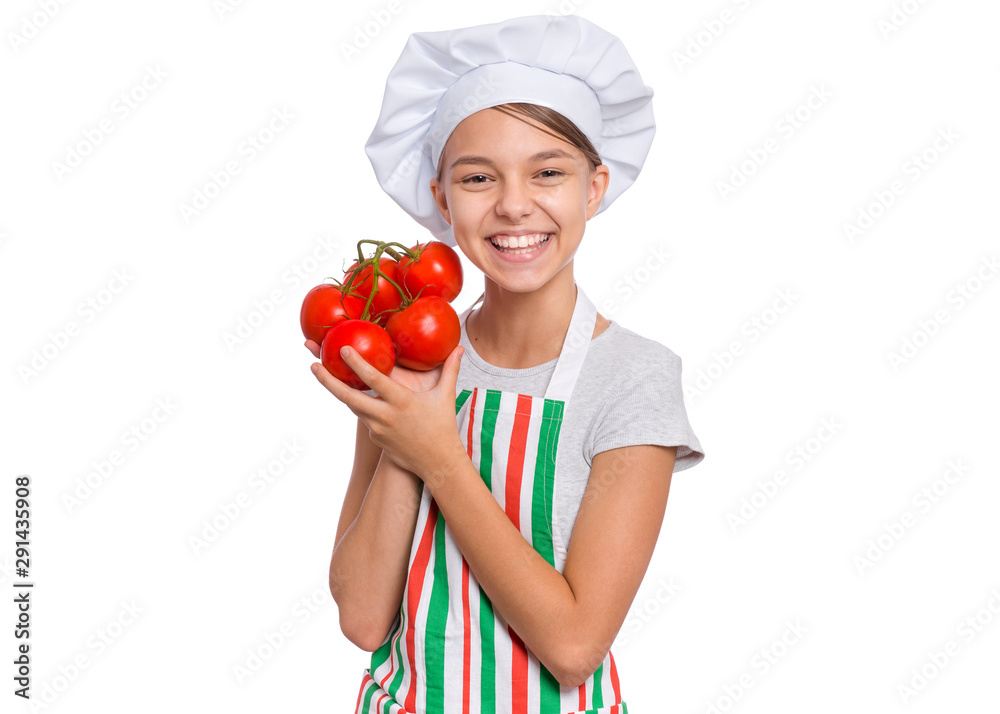 Happy teen girl in chef hat holds red tomatoes branch, isolated on white background. Portrait of smiling child cook in apron shows delicious vegetables in hands. Organic natural healthy food produce. Happy teen girl in chef hat holds red tomatoes branch, isolated on white background. Portrait of smiling child cook in apron shows delicious vegetables in hands. Organic natural healthy food produce.