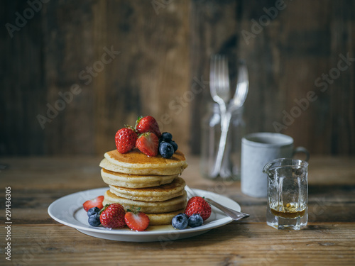 pancakes topped with strawberry and blueberry