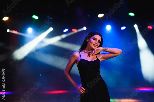 Young woman having fun, going crazy alone, bright sexy make up, funny party, night image with flash.