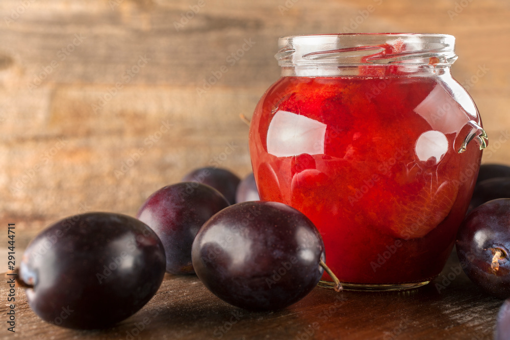 Preservation of freshly picked plums on a rustic wooden background Preservation of freshly picked plums on a rustic wooden background
