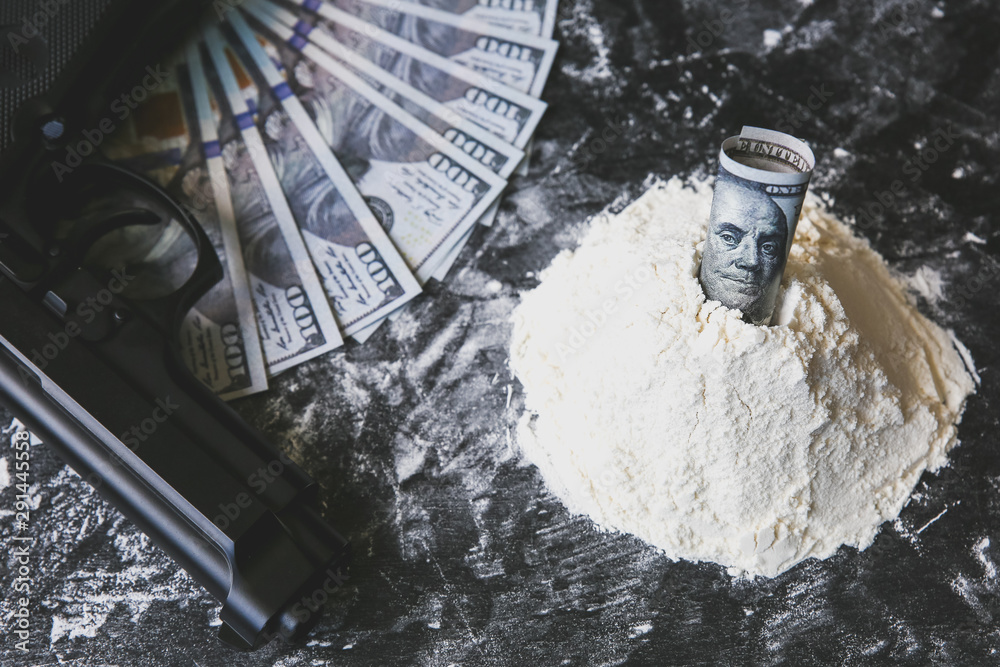 Cocaine with dollar notes on the table. Drugs addict dealer. Dangerous gun. Unhealthy life concept. Cocaine with dollar notes on the table. Drugs addict dealer. Dangerous gun. Unhealthy life concept.