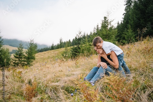 Young mom with baby boy travelling. Mother on hiking adventure with child  family trip in mountains. National Park. Hike with children. Active summer holidays.