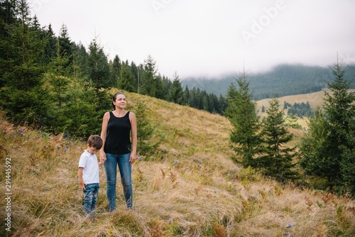 Young mom with baby boy travelling. Mother on hiking adventure with child, family trip in mountains. National Park. Hike with children. Active summer holidays.