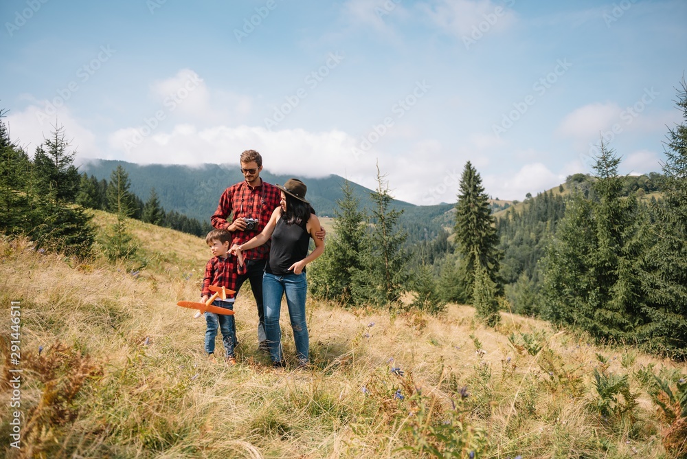 Father and child hiking in scenic mountains. Dad and son enjoying the view from the mountain top in Carpathian mountains