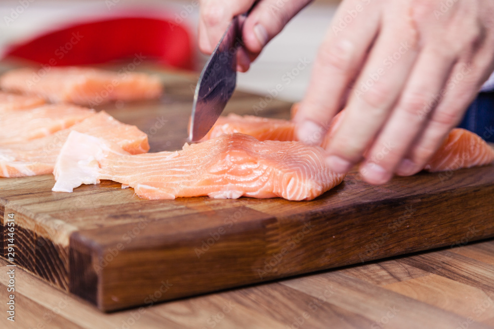 Slicing salmon fillets.