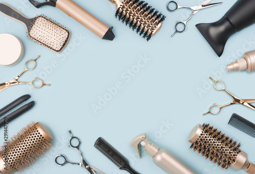 фотографія Professional hairdressing tools and accessories on blue background with space