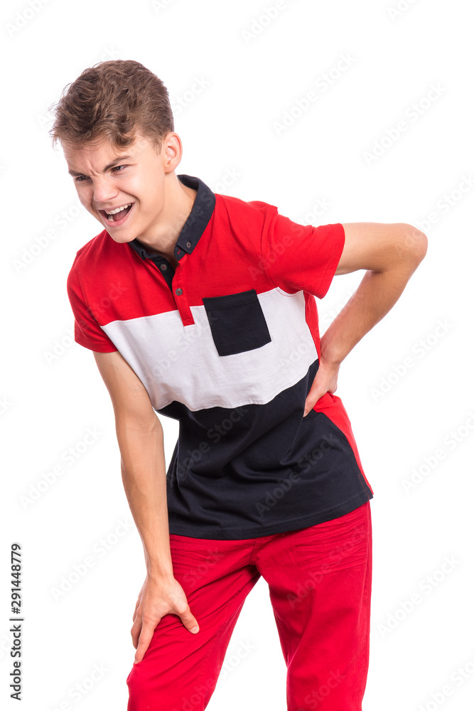 Portrait of unhappy teen boy suffering from backache, isolated on white  background. Upset child massaging his back suffering from discomfort ache  pain. Cute young teenager hands touching back pain. foto de Stock |