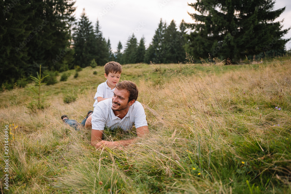 Happy father and little child are walking in the mountains. Father's Day. vacation in the national park Happy father and little child are walking in the mountains. Father's Day. vacation in the national park