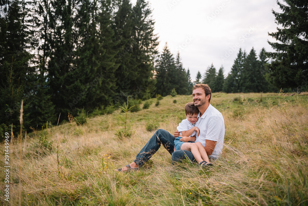 Happy father and little child are walking in the mountains. Father's Day. vacation in the national park