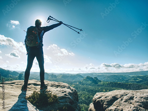 Tourist or hiker man with backpack and trekking poles