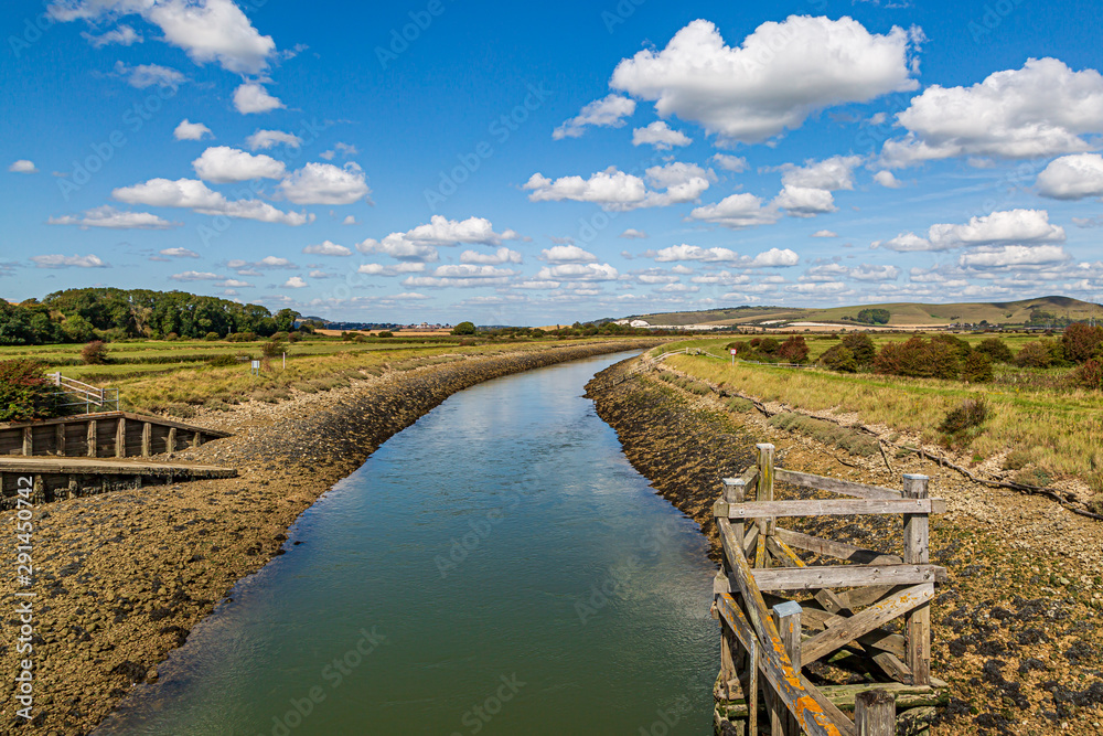 Fototapeta premium Looking along the River Ouse in Sussex, from a bridge near Southease