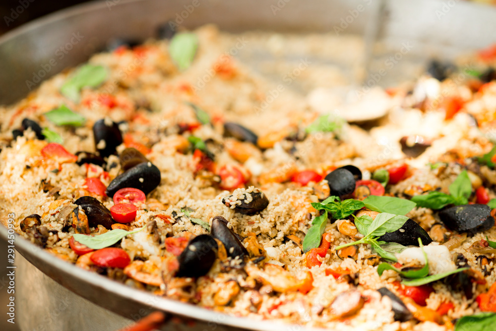 Close up of pilaf with mussels in big bowl for sale on city picnic Close up of pilaf with mussels in big bowl for sale on city picnic