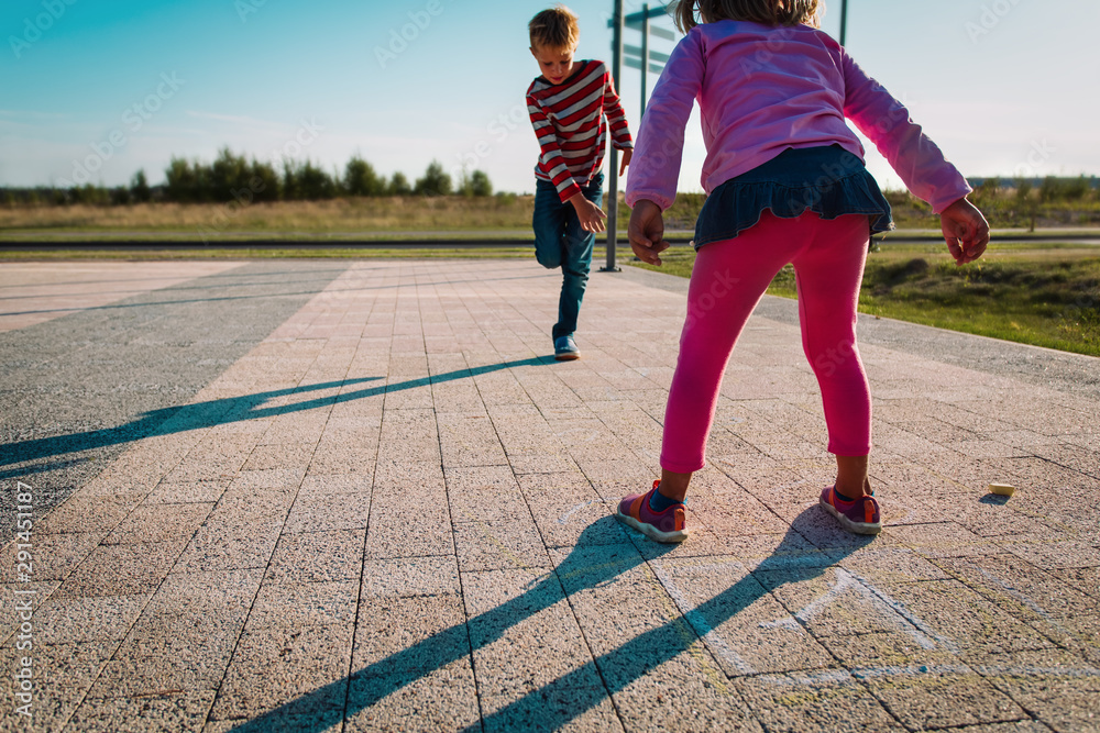 kids playing hopscotch on playground outdoors, playtime