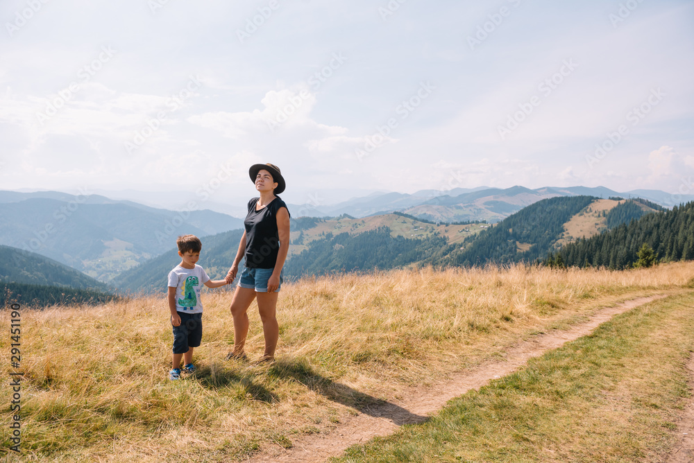mother and son having rest on vacation in mountains