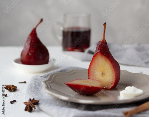 Red wine poached pears in a plate, delicious french dessert