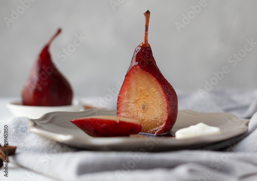 Red wine poached pears in a plate, delicious french dessert