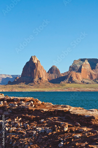 The golden red rocks on the shores of the lake powell landscape/.