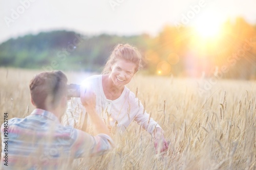 Couple walking across field of corn