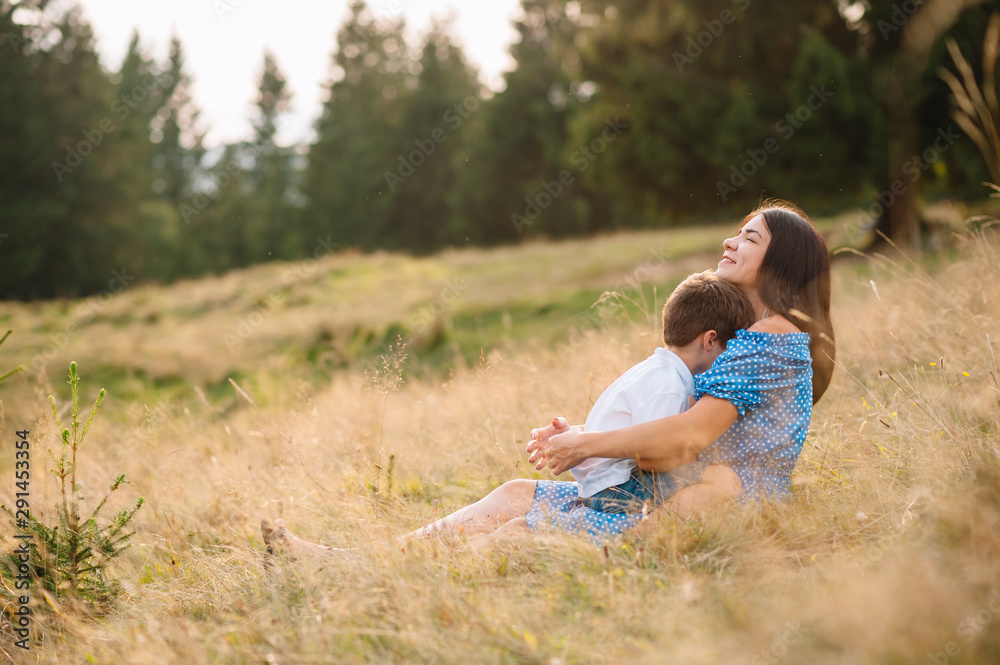 mother and son having rest on vacation in mountains. Young family with child resting on a mountain. vacation in the national park mother and son having rest on vacation in mountains. Young family with child resting on a mountain. vacation in the national park