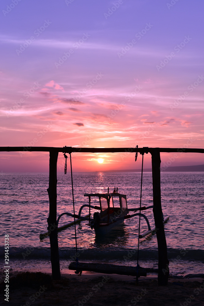 A wooden boat moored in Gili Meno during sunrise, Gili Islands, Indonesia