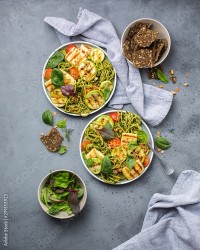Green pasta with grilled cheese, grilled zucchini, nuts and herbs. Vegetarian perfect lunch