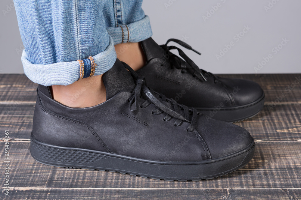 black leather shoes on male legs, shopping concept black leather shoes on male legs, shopping concept