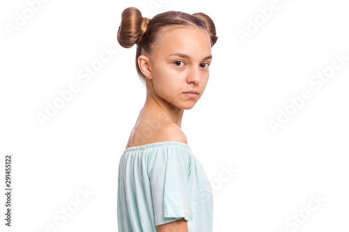 Portrait of happy teen girl with funny hairstyle, isolated on white background. Smiling child looking at camera. Beautiful young caucasian teenager.