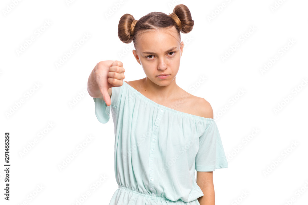 Portrait of teen girl giving thumb down gesture looking with negative expression and disapproval. Beautiful caucasian young teenager doing bad signal, isolated on white background. Portrait of teen girl giving thumb down gesture looking with negative expression and disapproval. Beautiful caucasian young teenager doing bad signal, isolated on white background.