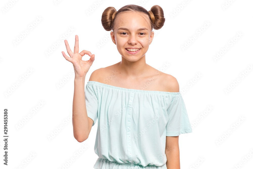 Portrait of teen girl making Ok Gesture, isolated on white background. Beautiful caucasian young teenager smiling and giving OK sign. Happy cute child showing okay.