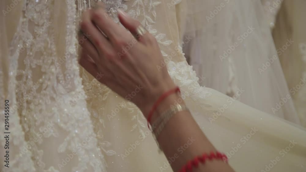 Beautiful girl chooses a wedding dress in a bridal salon. Beautiful girl chooses a wedding dress in a bridal salon.