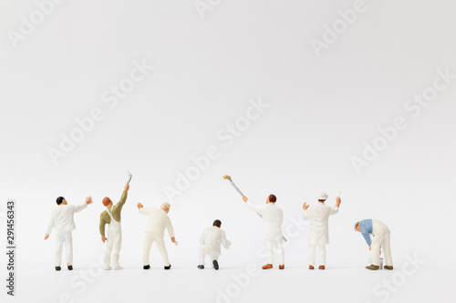 Miniature people : Painter holding a brush with  space for text photo