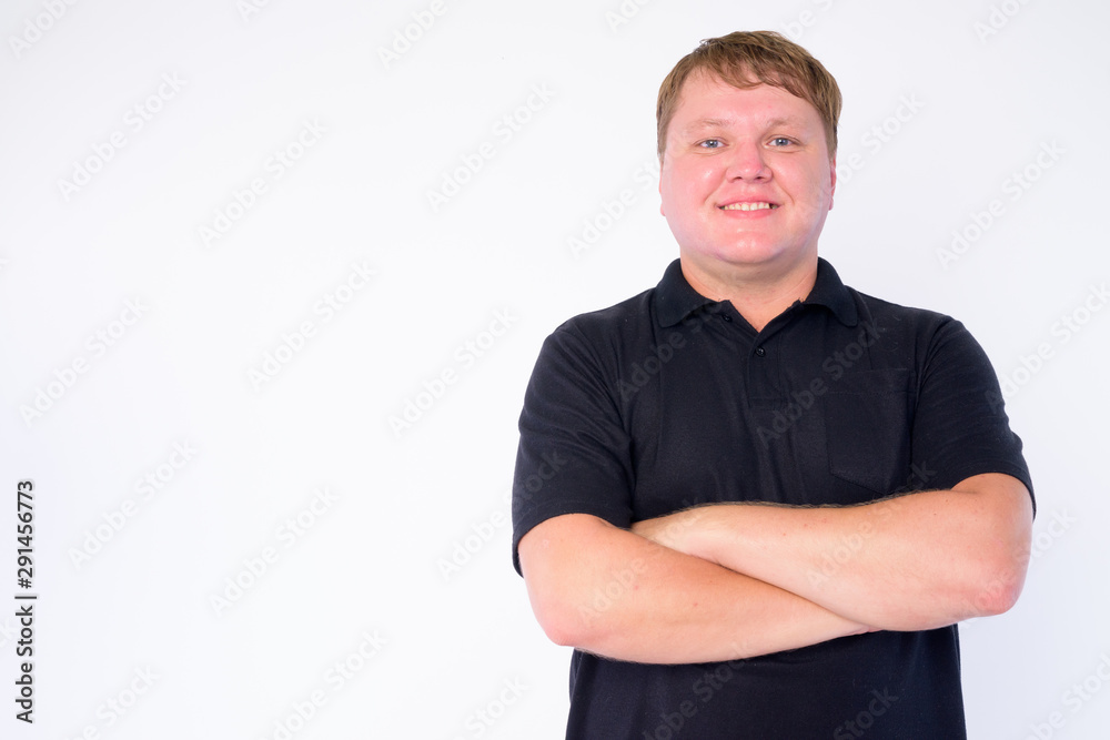 Portrait of happy overweight man smiling with arms crossed Portrait of happy overweight man smiling with arms crossed