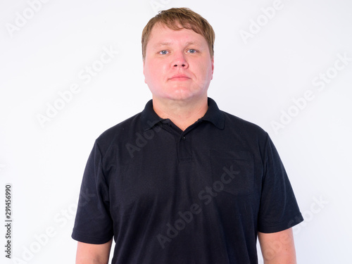 Portrait of overweight man looking at camera