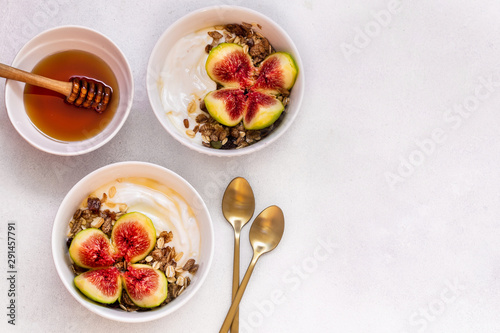 Breakfast with muesli, yogurt, figs in a bowl