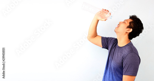 Obraz na plátně Attractive handsome asian man gets thirsty because of hot weather in the summer season on White background With copy space