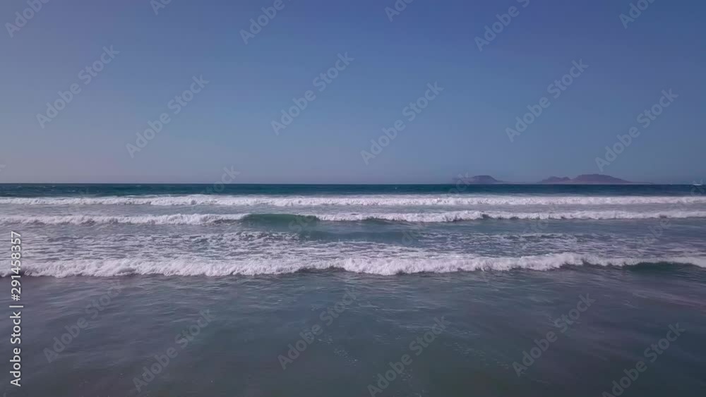 Waves rolling towards a sand beach Waves rolling towards a sand beach