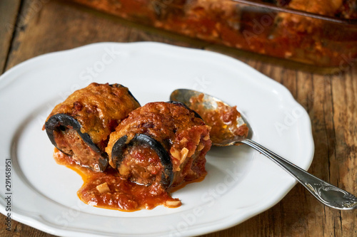 Eggplant rolls with minced meat and cheese in tomato sauce