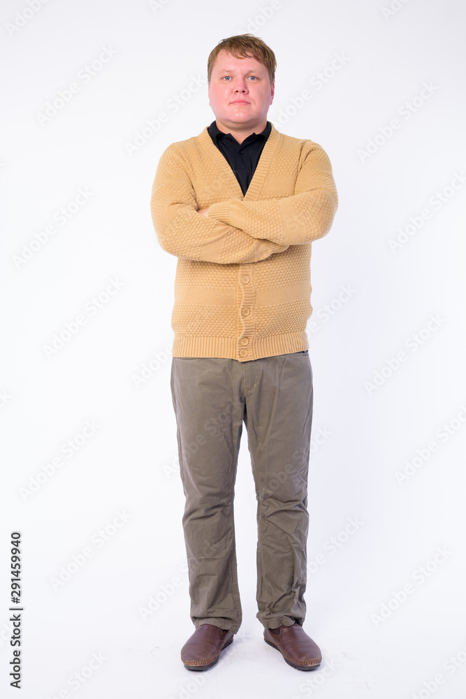 Full body shot of overweight man with arms crossed Full body shot of overweight man with arms crossed