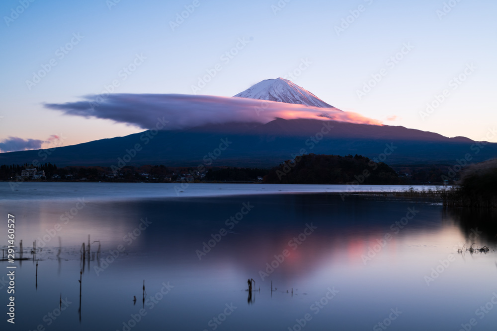 Beautiful scenery sunset of lake kawaguchi and mount Fuji with cloud cover some part of the mountain. Concept of relax, calm and nature background.