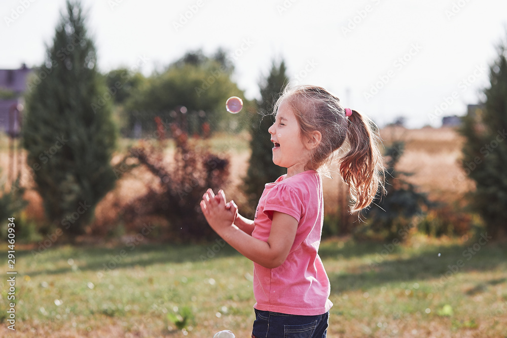 Little gir playing with soap bubbles Little gir playing with soap bubbles